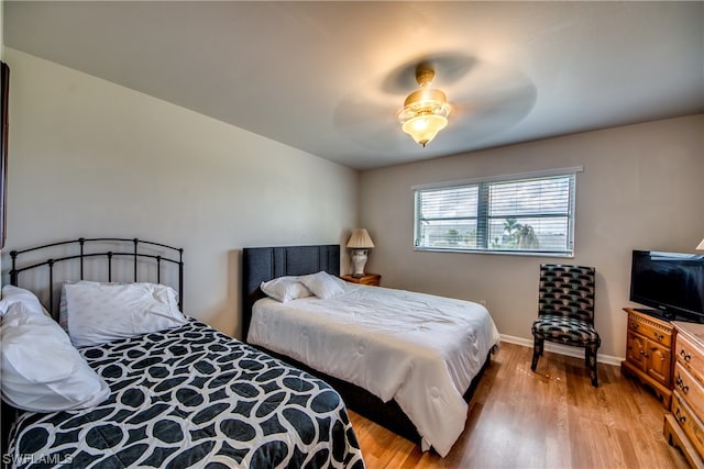 bedroom with light hardwood / wood-style floors and ceiling fan