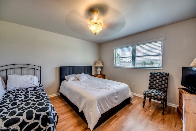 bedroom with ceiling fan and light wood-type flooring