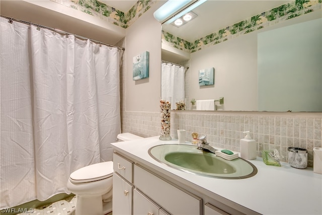 bathroom featuring tile walls, tasteful backsplash, toilet, and large vanity