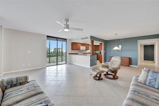 living room featuring ceiling fan, light tile patterned floors, and a wall of windows