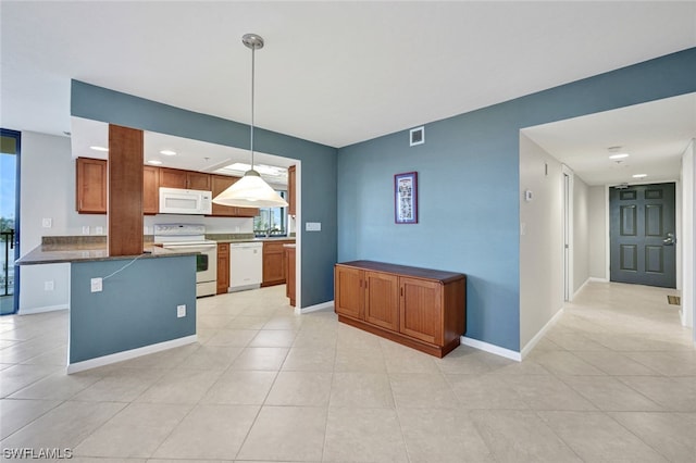 26235 Hickory Blvd Unit 4B, Bonita Springs, FL 34134 - kitchen featuring white appliances, dark countertops, hanging light fixtures, light tile patterned floors, and brown cabinetry