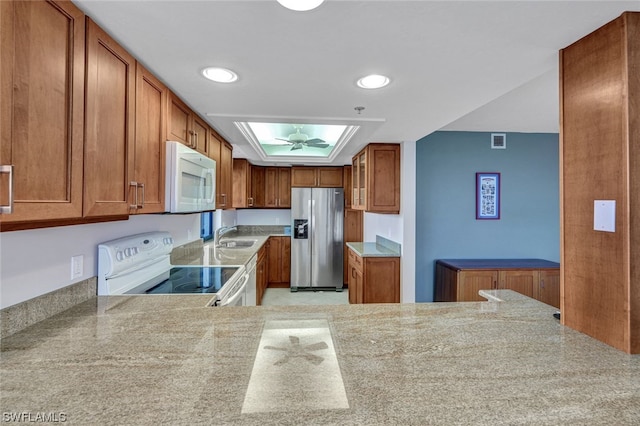26235 Hickory Blvd Unit 4B, Bonita Springs, FL 34134 - kitchen with white appliances, brown cabinetry, a sink, light countertops, and recessed lighting