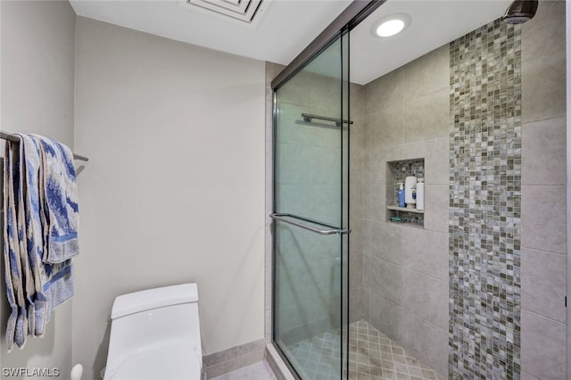 bathroom with toilet and walk in shower