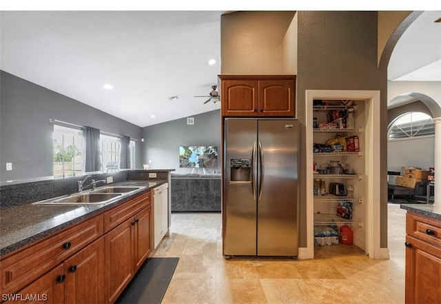 kitchen with ceiling fan, light tile floors, sink, vaulted ceiling, and stainless steel refrigerator with ice dispenser