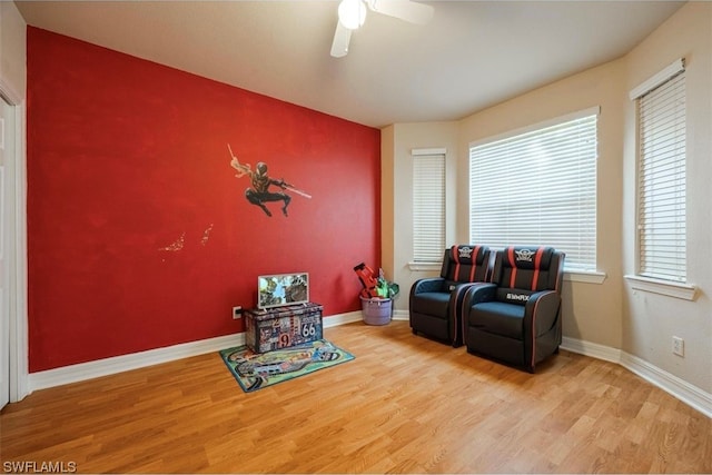 sitting room featuring light hardwood / wood-style floors and ceiling fan