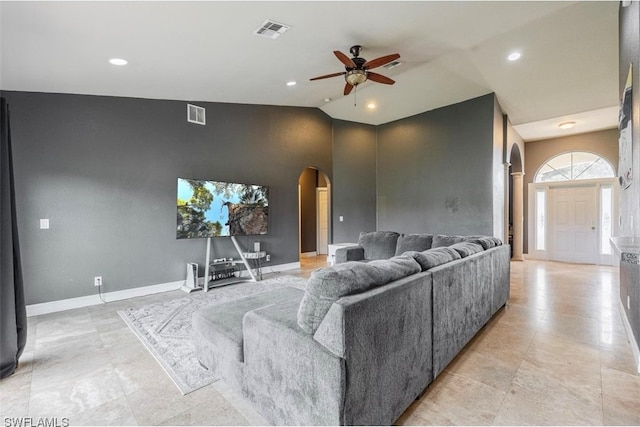 tiled living room featuring high vaulted ceiling and ceiling fan