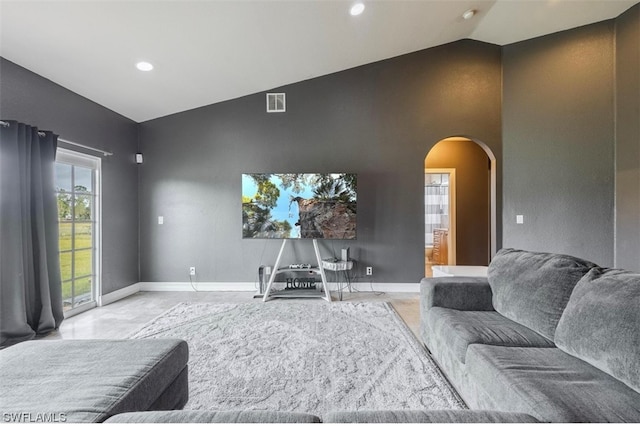 living room with high vaulted ceiling