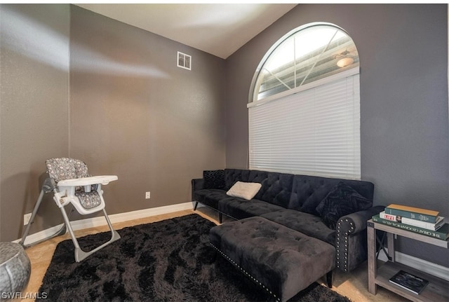 living room featuring lofted ceiling