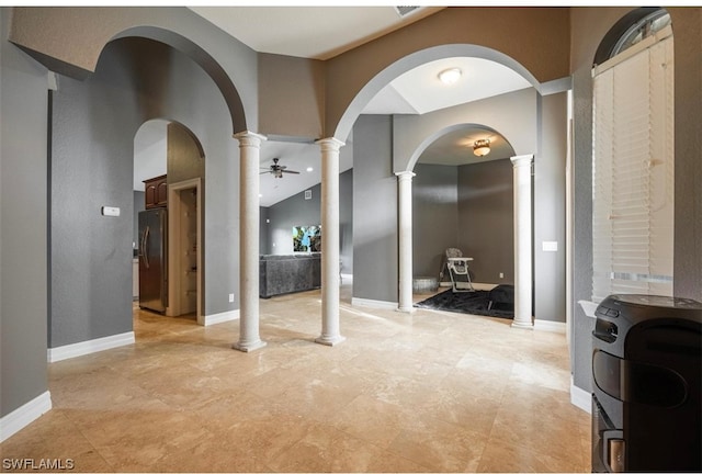 hall featuring ornate columns and light tile flooring