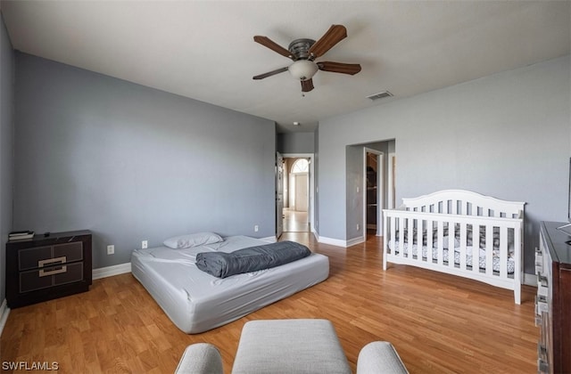 bedroom with light hardwood / wood-style floors and ceiling fan