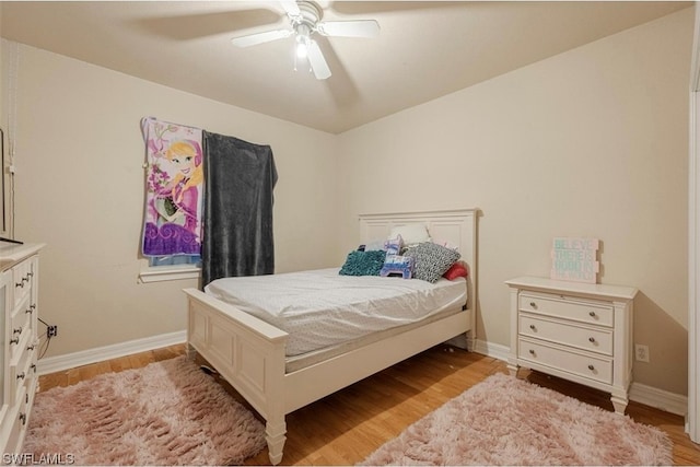 bedroom with light hardwood / wood-style floors and ceiling fan