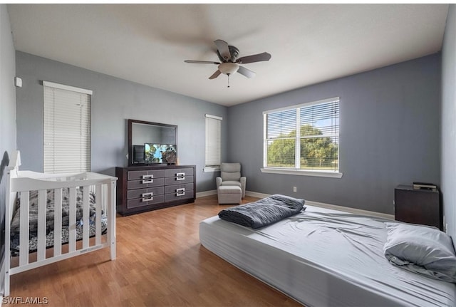 bedroom with ceiling fan and light wood-type flooring