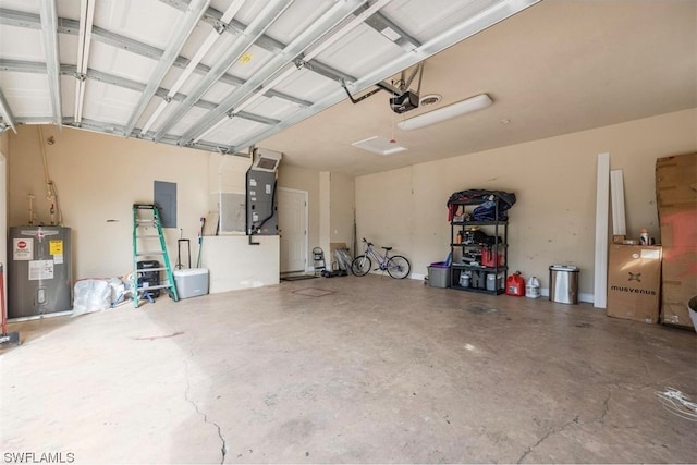 garage with electric water heater and a garage door opener