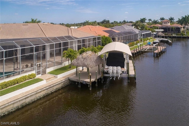 view of dock with a water view, boat lift, a residential view, and a lanai