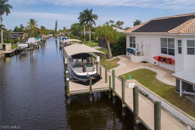 dock area with a water view and boat lift