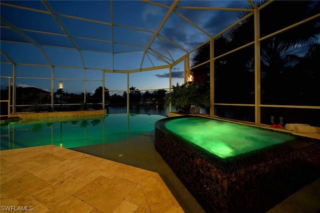 view of pool with a patio, a lanai, and a pool with connected hot tub