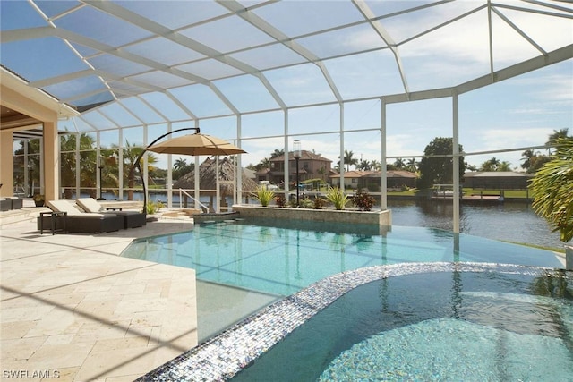 view of swimming pool featuring a patio, glass enclosure, and a pool with connected hot tub