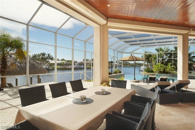 sunroom / solarium featuring a water view and wood ceiling