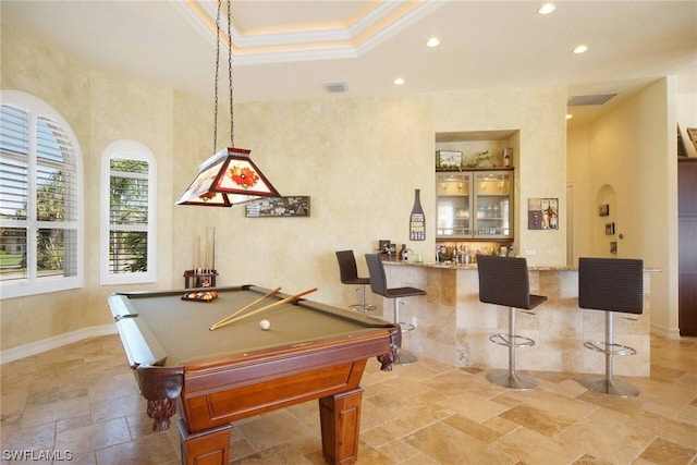 rec room featuring visible vents, a raised ceiling, ornamental molding, stone tile flooring, and recessed lighting