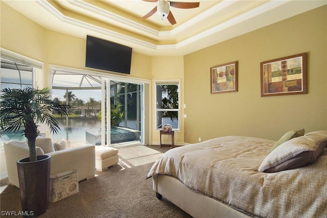 carpeted bedroom featuring a ceiling fan, a sunroom, access to exterior, a tray ceiling, and crown molding