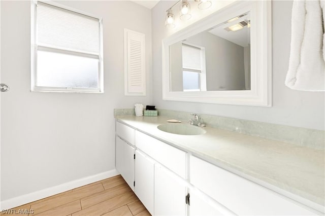 14865 Mango Ct, Captiva, FL 33924 - bathroom with baseboards, wood tiled floor, and vanity