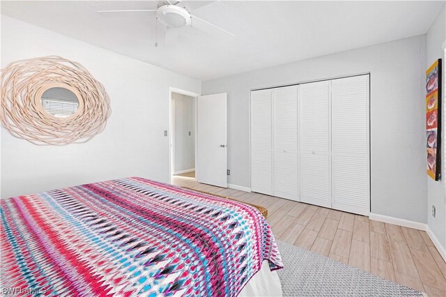 bedroom featuring light wood-type flooring, a closet, and ceiling fan