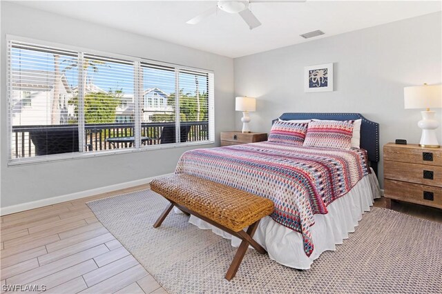 bedroom featuring ceiling fan, wood finished floors, visible vents, and baseboards