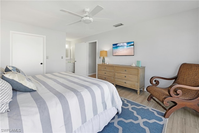 bedroom with light hardwood / wood-style flooring, connected bathroom, and ceiling fan