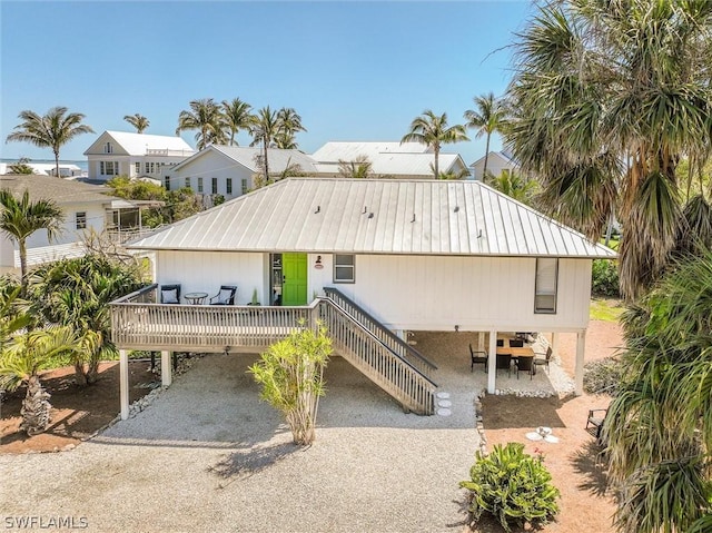 14865 Mango Ct, Captiva, FL 33924 - view of front of property with a carport, driveway, and metal roof