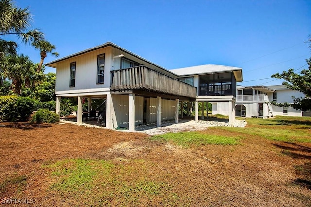 14865 Mango Ct, Captiva, FL 33924 - rear view of house with a lawn, a carport, and a sunroom