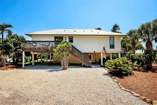 rear view of house featuring a carport