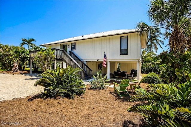 back of property featuring stairway and a patio area