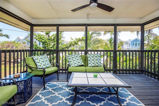 sunroom featuring a ceiling fan