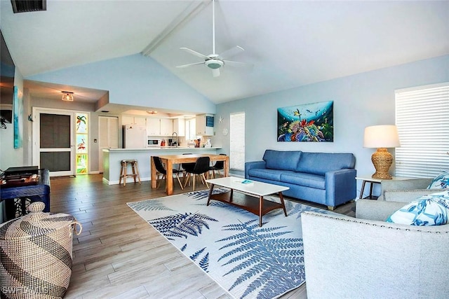 14865 Mango Ct, Captiva, FL 33924 - living area featuring visible vents, beam ceiling, high vaulted ceiling, a ceiling fan, and wood finished floors