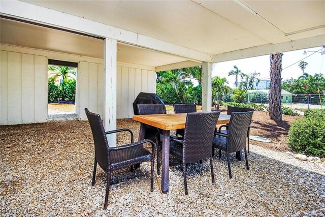 14865 Mango Ct, Captiva, FL 33924 - view of patio / terrace featuring outdoor dining space and fence