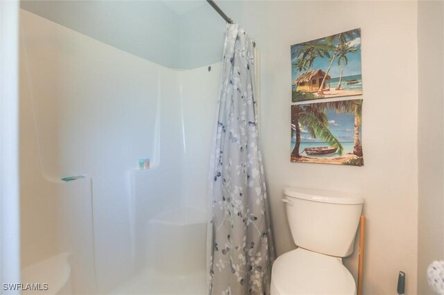 14865 Mango Ct, Captiva, FL 33924 - bathroom featuring toilet and a shower with shower curtain