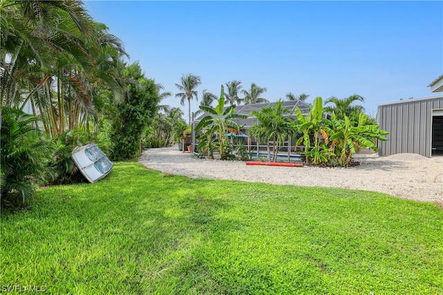 view of yard featuring a swimming pool and a lanai