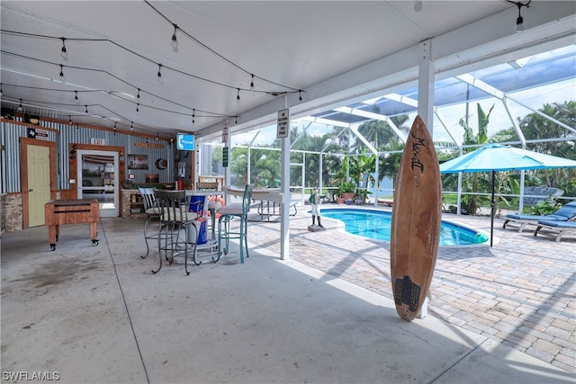 view of swimming pool with a patio and a lanai