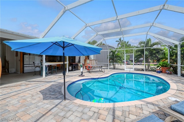 view of pool with a patio and a lanai