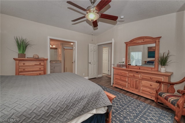 bedroom featuring connected bathroom, a textured ceiling, ceiling fan, and dark hardwood / wood-style flooring