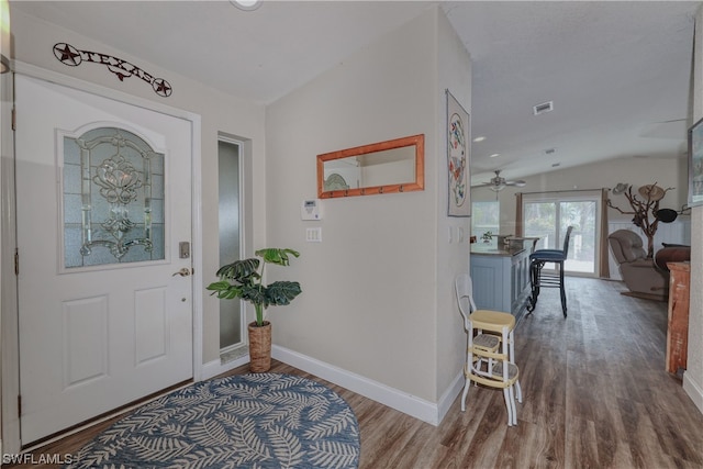 entryway featuring hardwood / wood-style floors, ceiling fan, and vaulted ceiling