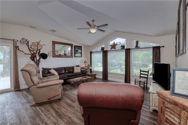 living room featuring dark hardwood / wood-style floors, ceiling fan, vaulted ceiling, and a wealth of natural light