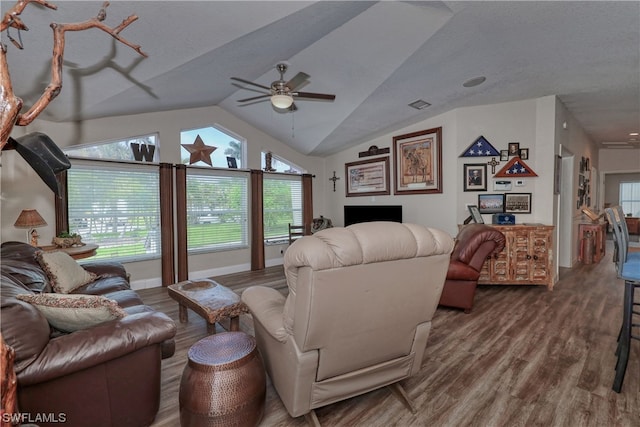 living room featuring vaulted ceiling, ceiling fan, and dark hardwood / wood-style flooring