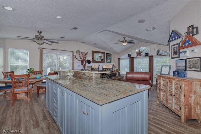 kitchen with a center island, ceiling fan, and light hardwood / wood-style flooring