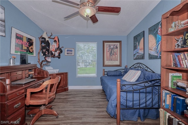 bedroom featuring vaulted ceiling, a textured ceiling, wood-type flooring, and ceiling fan