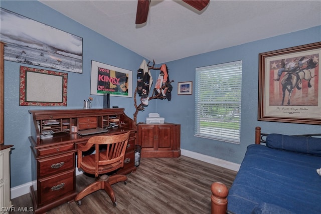 home office with dark hardwood / wood-style flooring and ceiling fan