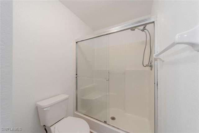 full bath with a stall shower and toilet