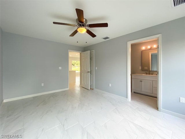 unfurnished bedroom with light tile floors, ensuite bath, ceiling fan, and sink