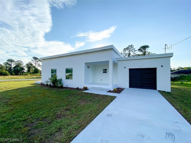 modern home with a front yard and a garage