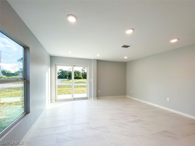 unfurnished room featuring light tile floors